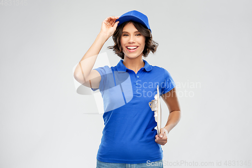 Image of happy smiling delivery girl with clipboard