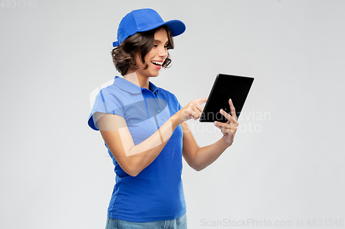 Image of happy smiling delivery girl with tablet computer