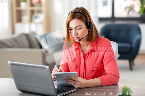 Image of woman with headset and laptop working at home