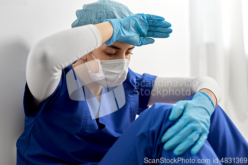 Image of sad doctor or nurse in protective face mask