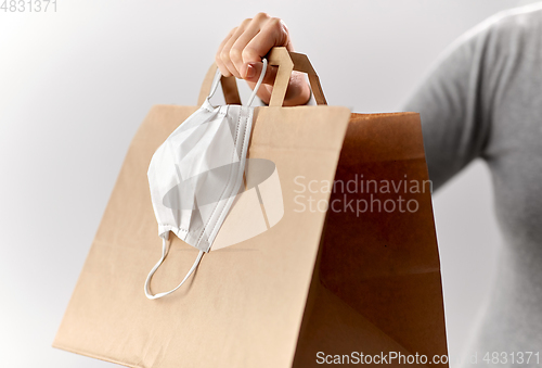 Image of woman with shopping bag and face protective mask
