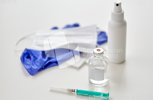 Image of syringe, medicine, wound wipes, gloves and mask