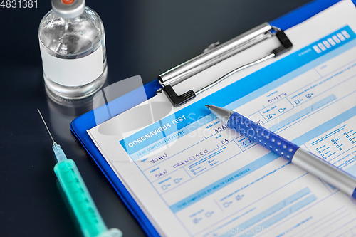 Image of medical report, pen, syringe and medicine