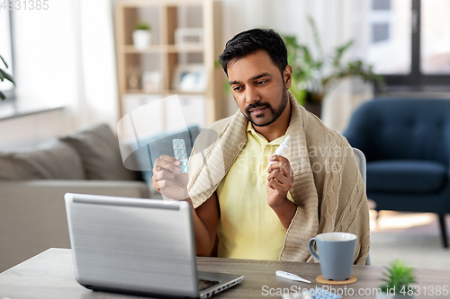 Image of sick man thermometer having video call on laptop