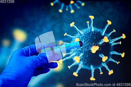 Image of hand holding beaker with coronavirus blood test