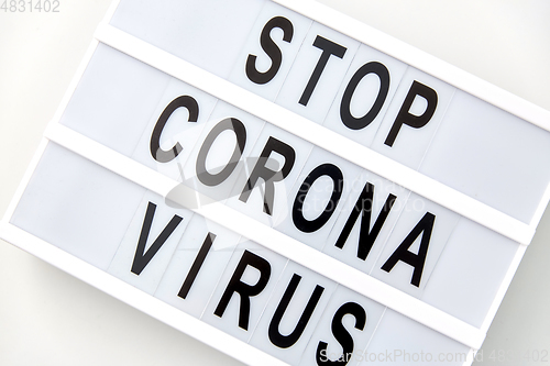 Image of close up of lightbox with stop corona virus words