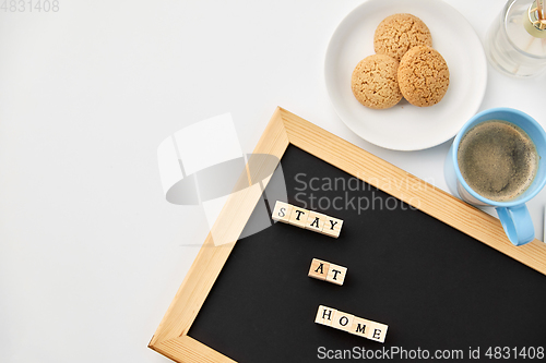 Image of chalkboard with stay at home words on toy blocks