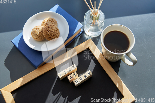 Image of chalkboard with stay at home words on toy blocks