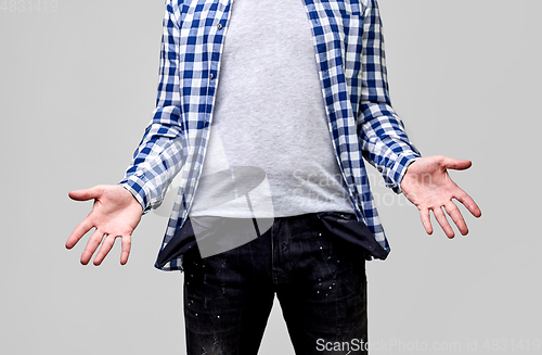 Image of close up of man showing empty pockets