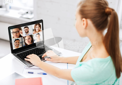 Image of woman with laptop has video call with colleagues