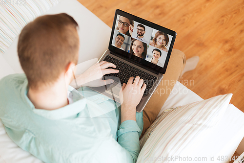 Image of man with laptop having video call with colleagues