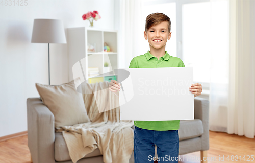 Image of happy boy holding white blank paper sheet at home