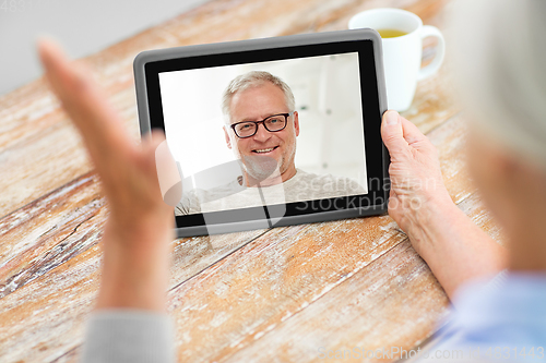 Image of senior woman having video call with senior man