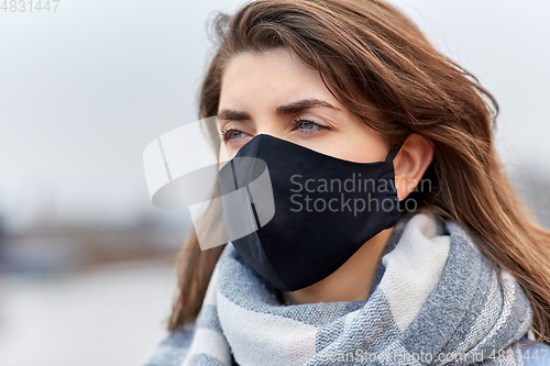 Image of woman wearing protective reusable barrier mask