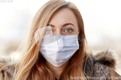 Image of young woman wearing protective medical mask