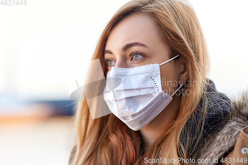 Image of young woman wearing protective medical mask