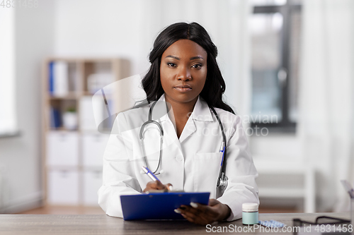 Image of african american doctor with clipboard at hospital