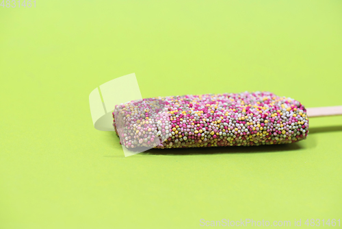 Image of Ice cream on stick with colorful sprinkles