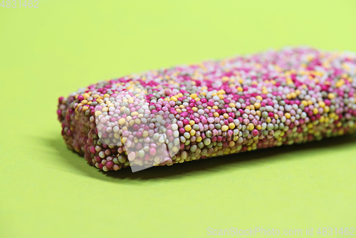 Image of Ice cream on stick with colorful sprinkles