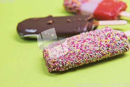 Image of Set of ice cream on stick with colorful sprinkles