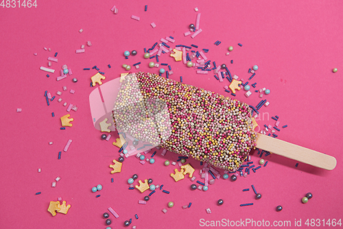 Image of Ice cream on stick with colorful sprinkles