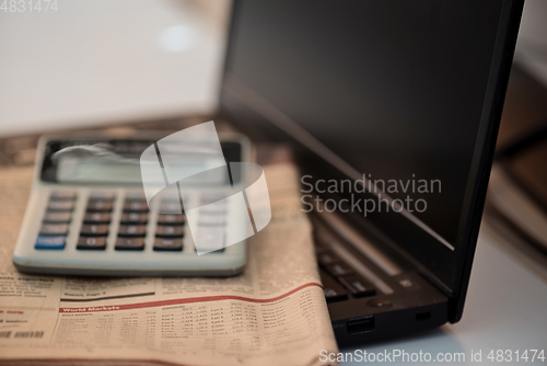 Image of Black notebook, calculator and finance newspaper. Coronavirus concept. Work from home concept