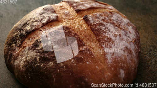 Image of Freshly baked natural bread is on the kitchen table.