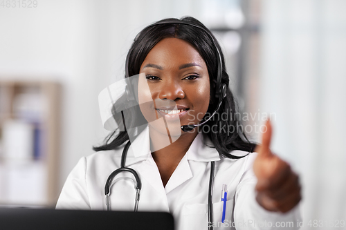 Image of african doctor with headset and laptop at hospital