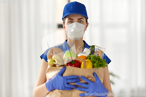 Image of delivery woman in face mask with food in paper bag