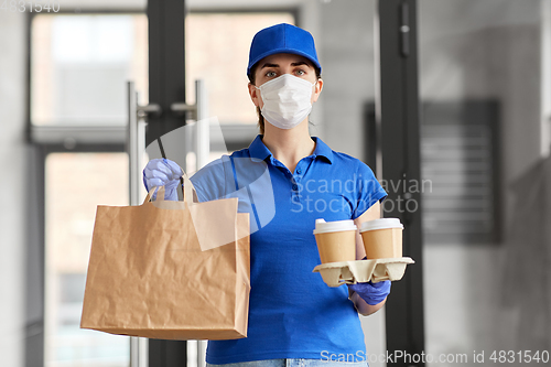 Image of delivery woman in face mask with food and drinks