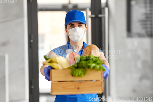 Image of delivery woman in face mask with food in box