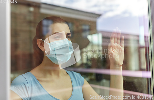 Image of sick young woman wearing protective medical mask