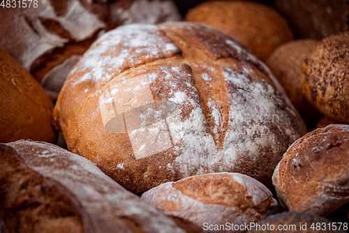 Image of Freshly baked natural bread is on the kitchen table.