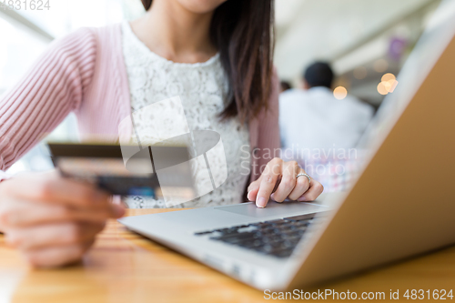 Image of Woman shopping with credit card and laptop computer
