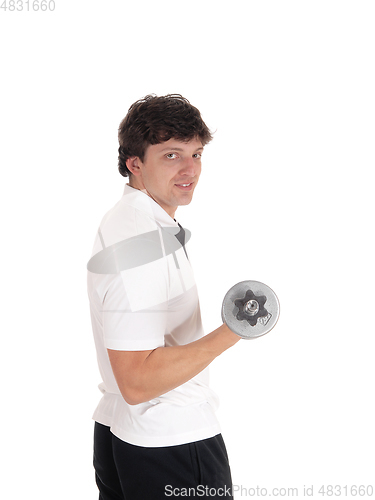 Image of Young man standing in profile lifting dumbbell