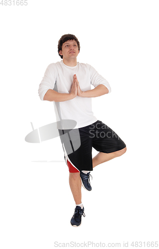 Image of Man standing on one leg doing yoga
