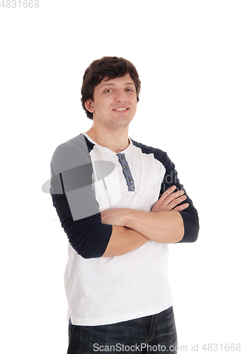 Image of Relaxed young man standing with his arms crossed