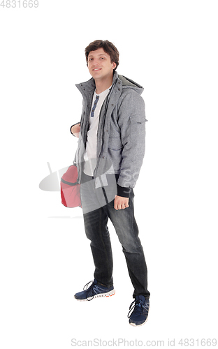 Image of Young man standing in jacket and gym back
