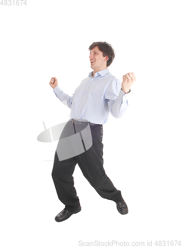 Image of Happy young man dancing in shirt and dress pants