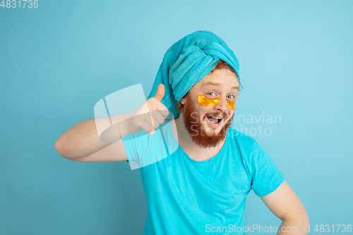 Image of Portrait of young caucasian man in his beauty day and skin care routine