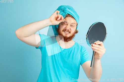 Image of Portrait of young caucasian man in his beauty day and skin care routine