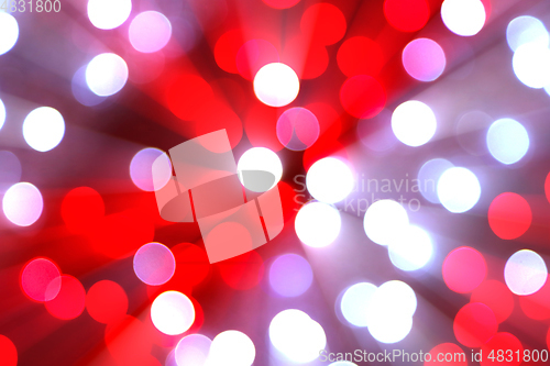 Image of Bright blurred lights and beams holiday background