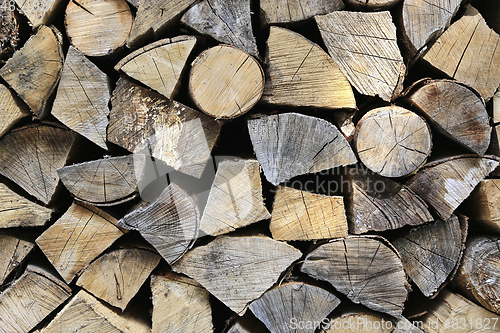 Image of Firewood pile stacked chopped wood trunks