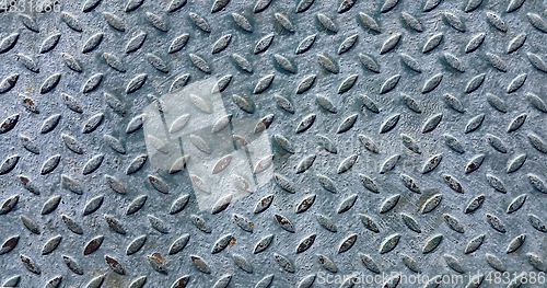 Image of Old metal diamond plate covered with paint