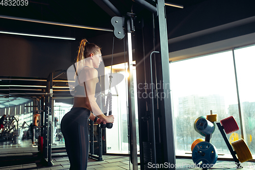 Image of The female athlete training hard in the gym. Fitness and healthy life concept.