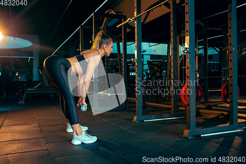 Image of The female athlete training hard in the gym. Fitness and healthy life concept.