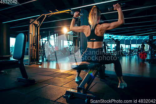 Image of The female athlete training hard in the gym. Fitness and healthy life concept.