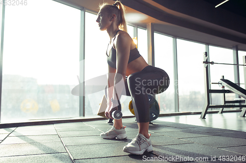 Image of The female athlete training hard in the gym. Fitness and healthy life concept.