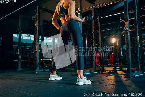 Image of The female athlete training hard in the gym. Fitness and healthy life concept.