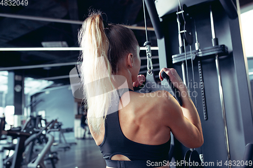 Image of The female athlete training hard in the gym. Fitness and healthy life concept.